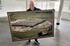 I.T.S - Founder Mike Bagshaw holds up a framed photo of the newly purchased site near Hungerford - 2100x1400