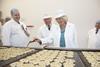 Charles and Camilla flipping Welsh cakes at Village Bakery