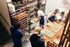 Farro bakers in action filling tarts and cruffins