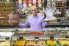 Cake Box CEO Sukh Chamdal holds up Asian sweet treats at an Ambala shop  2100x1400
