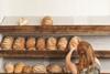 Woman stocking bakery shelves