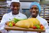 Paul and Mike Williams holding up a tray of patties