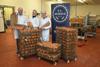 Three people inside a pork pie factory