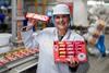 Rebecca Phillips, factory manager, FBC UK in a white coat and hairnet holding several packs of Jammie Dodgers