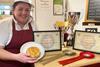 Lydia Sumter poses with her Minted Wensleydale Lamb & Potato Pie and trophies after being named Supreme Champion at the British Pie Awards 2024.  2100x1400