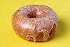 A Original Vanilla Bean Glaze Doughnut on yellow background