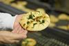 Signature Flatbreads - A worker check a flatbread in Dunstable