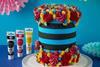 A blue and black cake with colourful swirls of frosting on