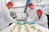 Vandemoortele - Workers at a croissant production line run by Vandemoortele