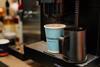 Fresh coffee being poured into a Warrens Bakery branded cup