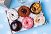 A festive doughnut box filled with six delicious looking doughnuts