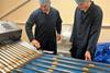 Elkes Biscuits factory service technician Aidan Fowell (left) and electrical engineer Connor Gratton check a biscuit production line  2100x1400