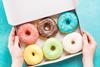 Coloured and glazed doughnuts in a box