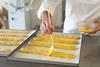 A pastry chef adding glaze to dough