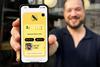 Embargo - Man displays phone with Blackbird Bakery app - 2100x1400