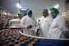 Workers at Wrights factory in Crewe watch the new cookie line