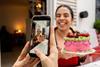 A person with a colourful cake on social media