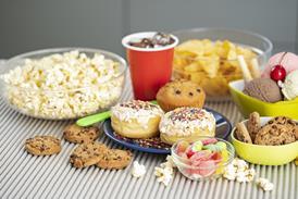 A selection of 'less healthy' foods including doughnuts, muffins, sweets, and ice cream