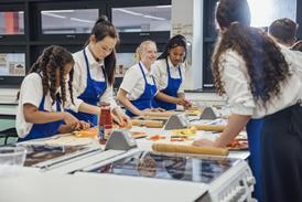 Teenagers making pizza in a classroom
