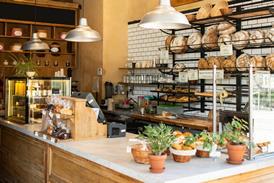 Inside a lovely looking bakery with loaves stacked on the walls