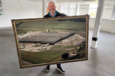 I.T.S - Founder Mike Bagshaw holds up a framed photo of the newly purchased site near Hungerford - 2100x1400