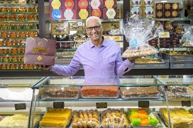 Cake Box CEO Sukh Chamdal holds up Asian sweet treats at an Ambala shop  2100x1400