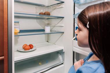 Girl looking into empty fridge