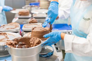 Lazy Day Foods - Staff apply chocolate frosting to a free-from cake - 2100x1400