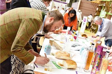 A judge assesses a loaf as part of the Farm Shop & Deli Product Awards 2023 at the Birmingham NEC in April.  2100x1400