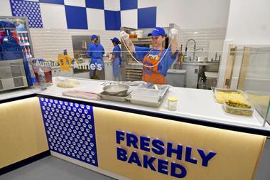 An Auntie Anne's staff member prepares a pretzel to be fresh baked at the Watford store  2100x1400
