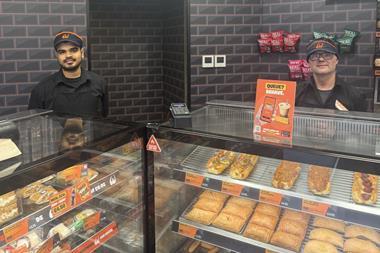 Two staff members behind the Wenzel's counter