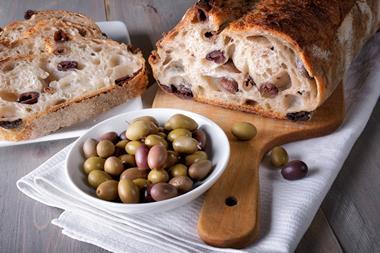 Olive sourdough with a bowl of olives