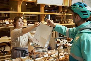 A Deliveroo rider picking up a bag from Gail's