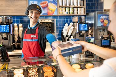 Greggs - A staff member serves a customer at the new Eco Drive-Thru shop in Winchester