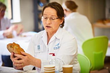 Sara Autton judging a loaf at the Britain's Best Loaf competition