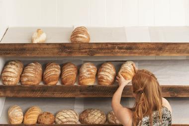Woman stocking bakery shelves