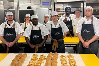Jacksons Bakery apprentices at The Sheffield College standing in aprons in front of buns