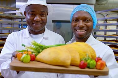 Paul and Mike Williams holding up a tray of patties