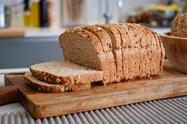 A sliced loaf with seeds on top in a modern kitchen