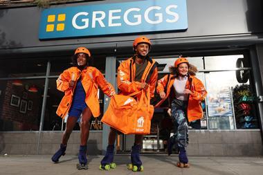 Greggs Just Eat team roller skating in front of Greggs shop
