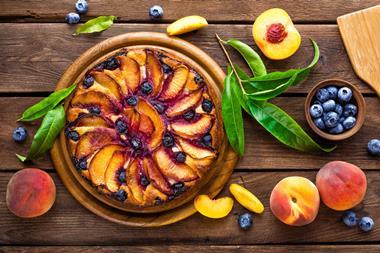 A lovely looking peach & blueberry tart on a wooden board