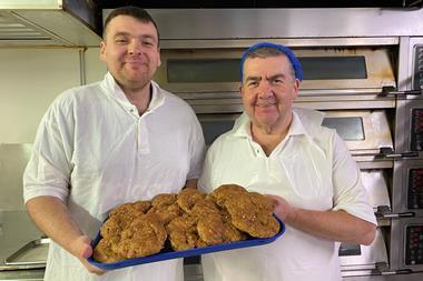 Hame Bakery owner Patrick Jackson (right) and his son, also a baker called Patrick, hold a tray of their new healthier butteries  - Food Standards Scotland