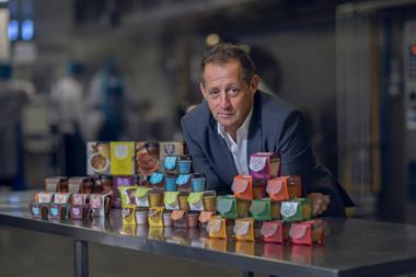 Pots & Co founder Julian Dyer in the London factory with the range of potted puddings