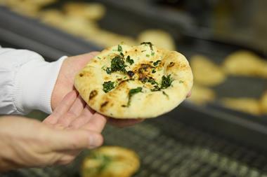 Signature Flatbreads - A worker check a flatbread in Dunstable