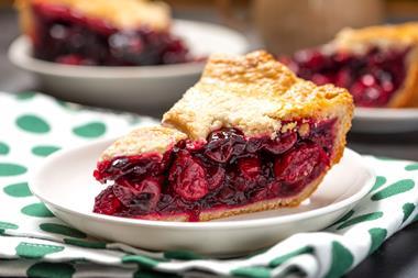 A close-up of a slice of cherry pie