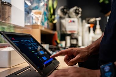 A worker types in an order using Vita Mojo POS software