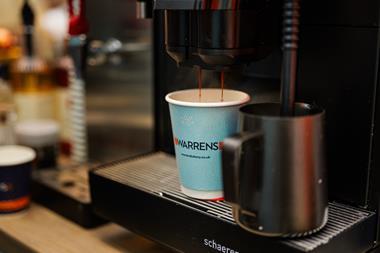 Fresh coffee being poured into a Warrens Bakery branded cup