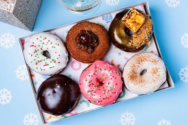 A festive doughnut box filled with six delicious looking doughnuts