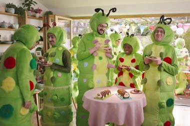 People dressed as caterpillars having a tea party