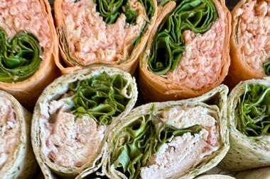 A selection of wraps filled with salad, chicken, and cheese